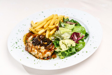meat with french fries and salad