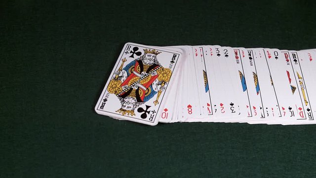 Playing Cards Falling against Green Background, Slow motion
