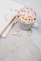 womans office table with coffee and marshmallows