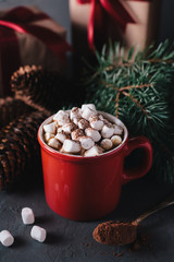 Hot chocolate or cocoa with marshmallows on gray background. Christmas presents. Holiday concept.
