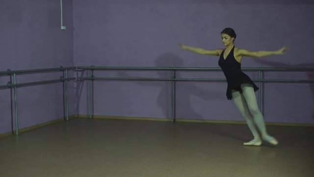 Pretty ballerina making a pose in a hall
