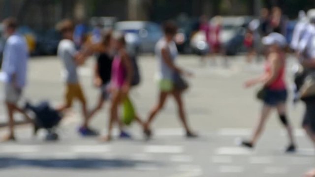 Side view blurred pedestrians  crossing a street in the city of Barcelona in summer.Time lapse