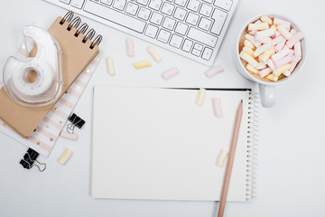 womans office table with coffee and marshmallows