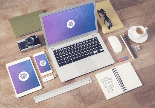 Laptop, Tablet, and Smartphone on Wooden Table with Note and Creative Tools Mockup