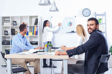 Obraz premium Group Of Business People Having Meeting In Office. Business partners discussing documents and ideas at meeting