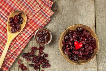 Dried cranberries in a bowl. Healthy superfood. Dried cranberries on the kitchen table. Diet food.
