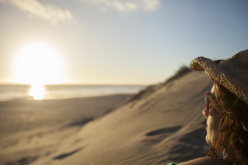 Profile of an adult woman watching the sunset on a beach at Conejo.  Baja California, Mexico.