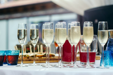 Champagne poured into glasses standing.