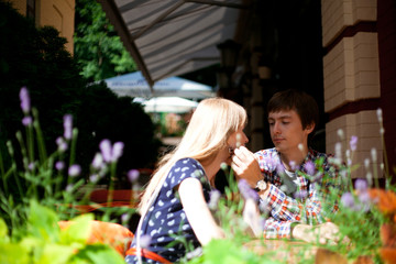 Portrait of young couple sitting at outdoor cafe