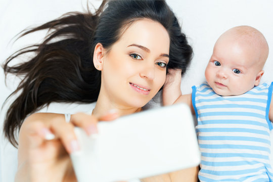 Funny Baby And Mother Make Selfie On Mobile Phone