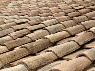 Old roof tiles on the roof of an old house