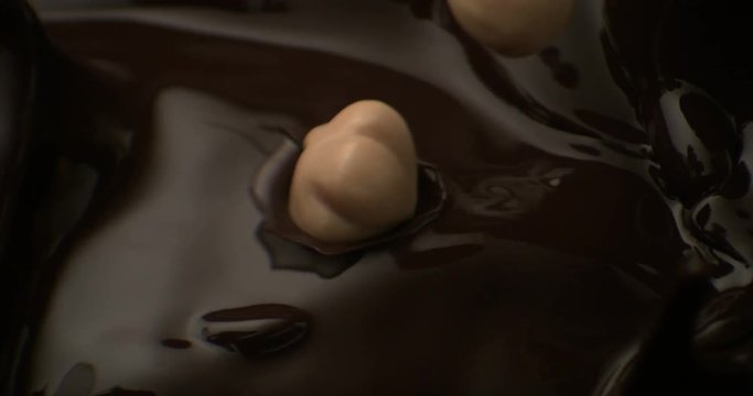 dusting of cocoa powder falls on the liquid chocolate in super slow motion