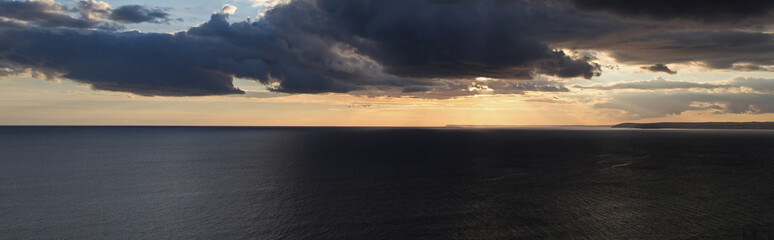 Beautiful sunset seascape over the sea with distant headlands.