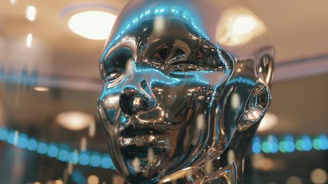 Silver color, mirror surfaces of face humanoid ( human ) reflects lights and rays of light from the surrounding space. Liquid metal face