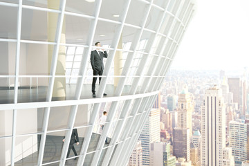 Businesspeople inside glass building