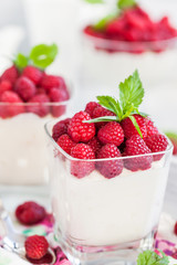 Delicious sweet  mousse decorated with fresh raspberries