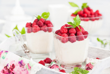 Delicious sweet  mousse decorated with fresh raspberries