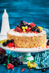 Delicious homemade honey cake decorated with fresh fruits