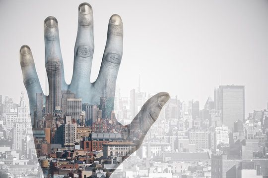 Hand on city background