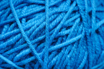 Woolen yarn ball, skein of tangled blue sewing threads, selective focus 