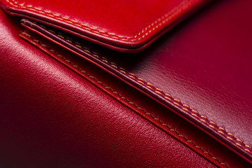 Red leather bag with pocket and stitches, woman's accessories, fashion industry, macro shot, selective focus, abstraction 