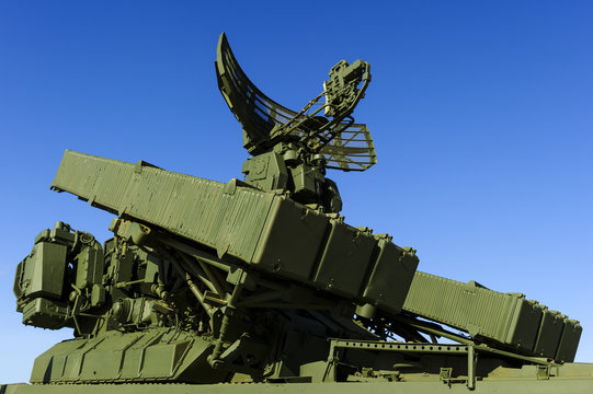Missile launcher with six ballistic missiles ready to attack and radar on top of army transportation, antiaircraft forces, military industry, blue sky on background 