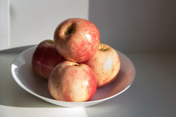 red apples on a white plate