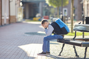 schoolboy crying on the street