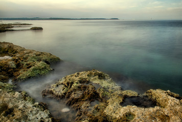 Mediterranean seaside with rocks in the morning, long time exposure