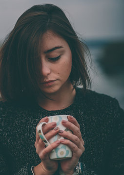 Woman With Pink Nails Holding A Hot Cup Of Coffee