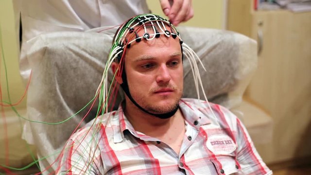 Electroencephalogram doctor places the electro