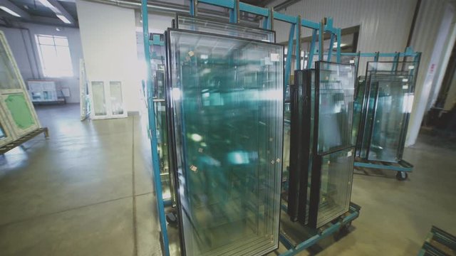 Plastic windows. Glass unit. Double glazing. The production line at the factory of plastic windows. Manufacture of glass and window systems. Small-scale industry.