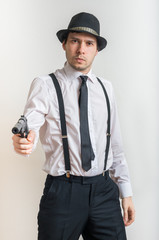 Young detective is aiming with gun with silencer.