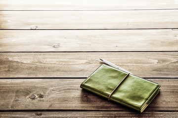  Notebook.On wooden desk table. Lighting the morning sun from window.