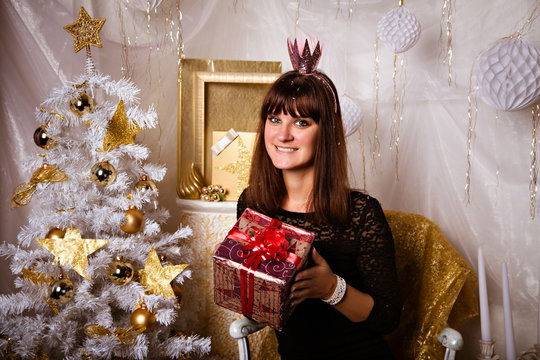 Woman in image of princess with Christmas gifts 