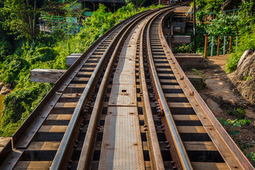 Fototapeta premium Railroad track curve around a bend in thailand