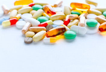 Vitamins, omega 3, cod-liver oil, dietary supplement and tablets an embankment on a light background close up, the top view