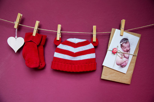 Baby clothes and greeting card hanging on the clothesline.