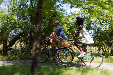 Fototapeta premium Young multiethnic couple having a bike ride in nature