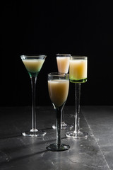 eggnog in liqueur glasses on a dark background 