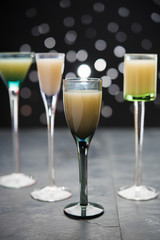 eggnog in liqueur glasses on a dark background 