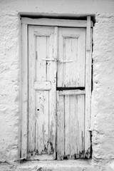 old rotted white door bw