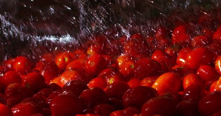 Super slow motion of tomatoes industrial washing with clean cold water splash drops in a factory in 4k (close up) - Powered by Adobe