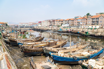 Fototapeta na wymiar Wooden fishing boats in the village of Shazikou, in the outskirts of Qingdao, Shandong, China