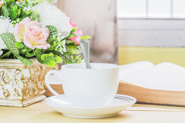 image of a cup of coffee with opened bible and flower on wooden table