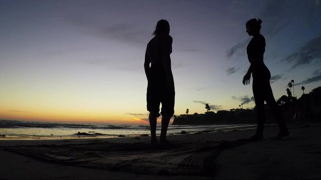 Acroyoga lifestyle beach sunset, silhouette beauty shot.