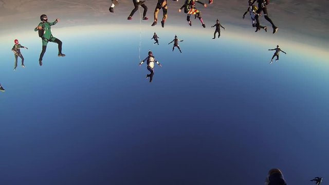 Group skydivers falling in blue sky make formation. Extreme hobby. Professionals. Adrenaline.