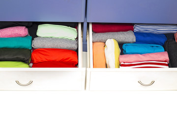 Clothing lying in the drawer in the wardrobe. on white backgroun