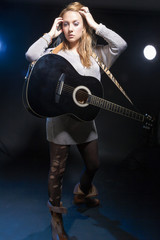 Fototapeta na wymiar Musical Concepts and Ideas. Caucasian Blond Female Posing with Guitar