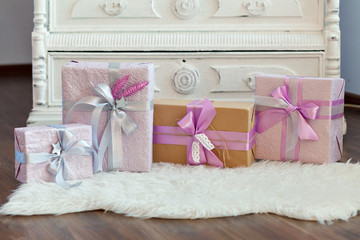 Holiday gift boxes decorated with ribbon. Beautiful purple shiny package for Christmas and New Year. Sebebryannaya tape